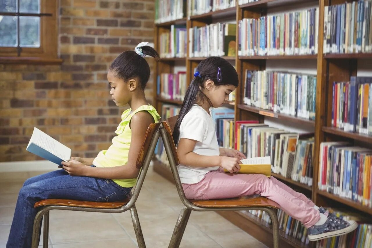 She is learning to read. A pupil reading book. pupils are reading. pupils are reading with pupils.