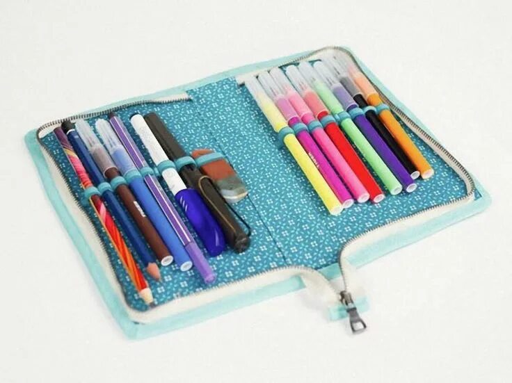 A pencil case in the desk. Pencil case with pencils. mm pencil case. pencil case with things. school items pencil case.
