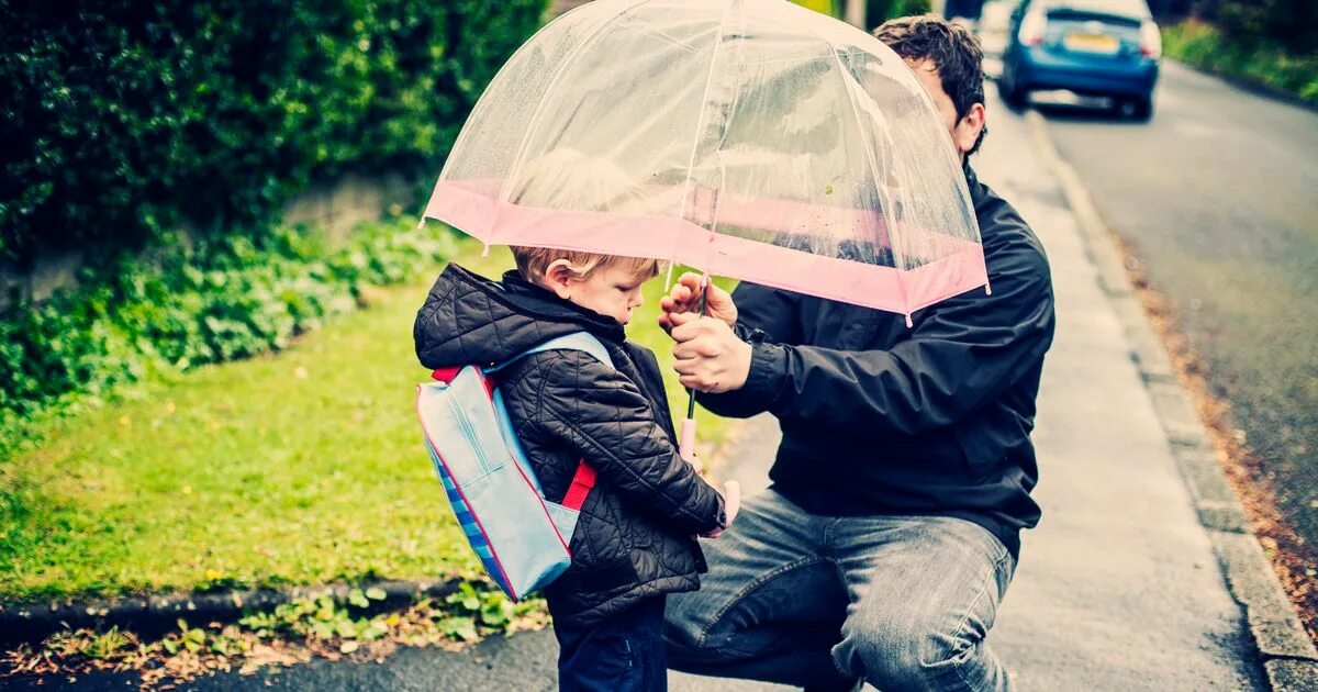 Take an Umbrella. A boy holding an Umbrella to his daughter. You take an umbrella today