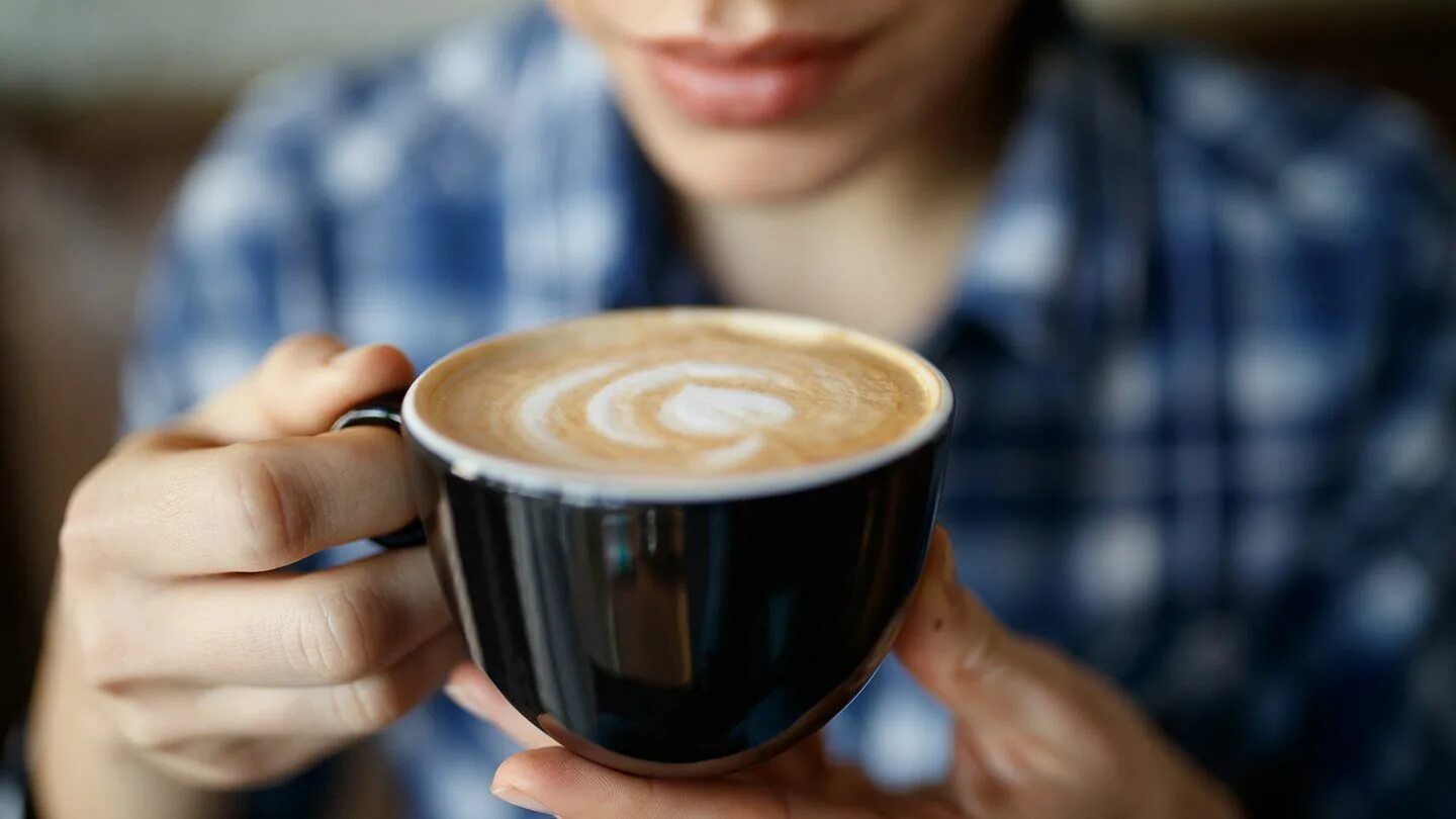 Drinking coffee she