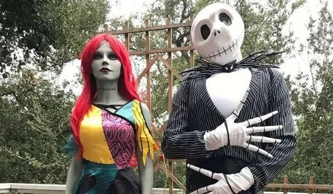 A couple wearing a Jack Skellington and Sally halloween costume.
