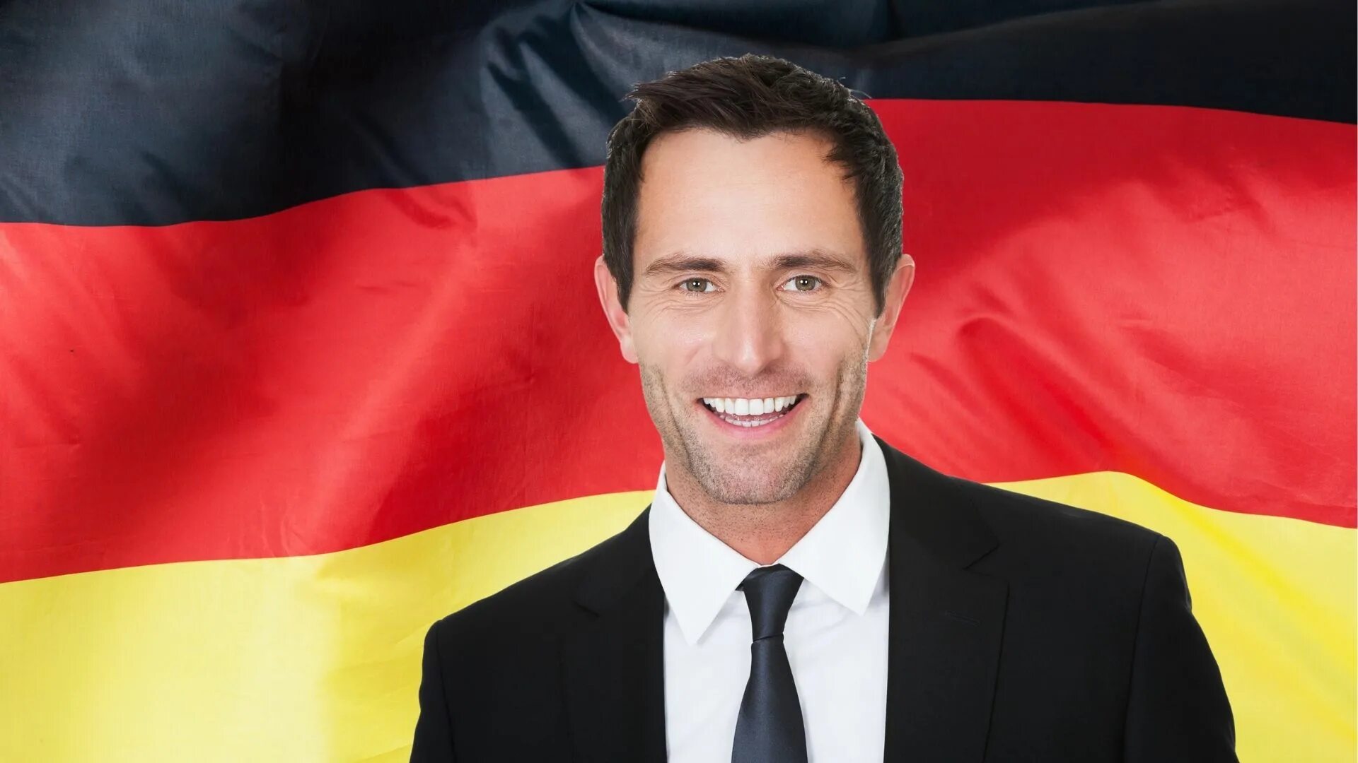 Ульрих грилло. Молодой германский бизнесмен. Мужчина с немецким флагом. Бизнесмен по немецки. Бизнесмен по немецки.