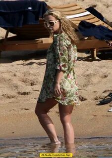 Anastacia sunbathing in yellow bikini in Porto Cervo.