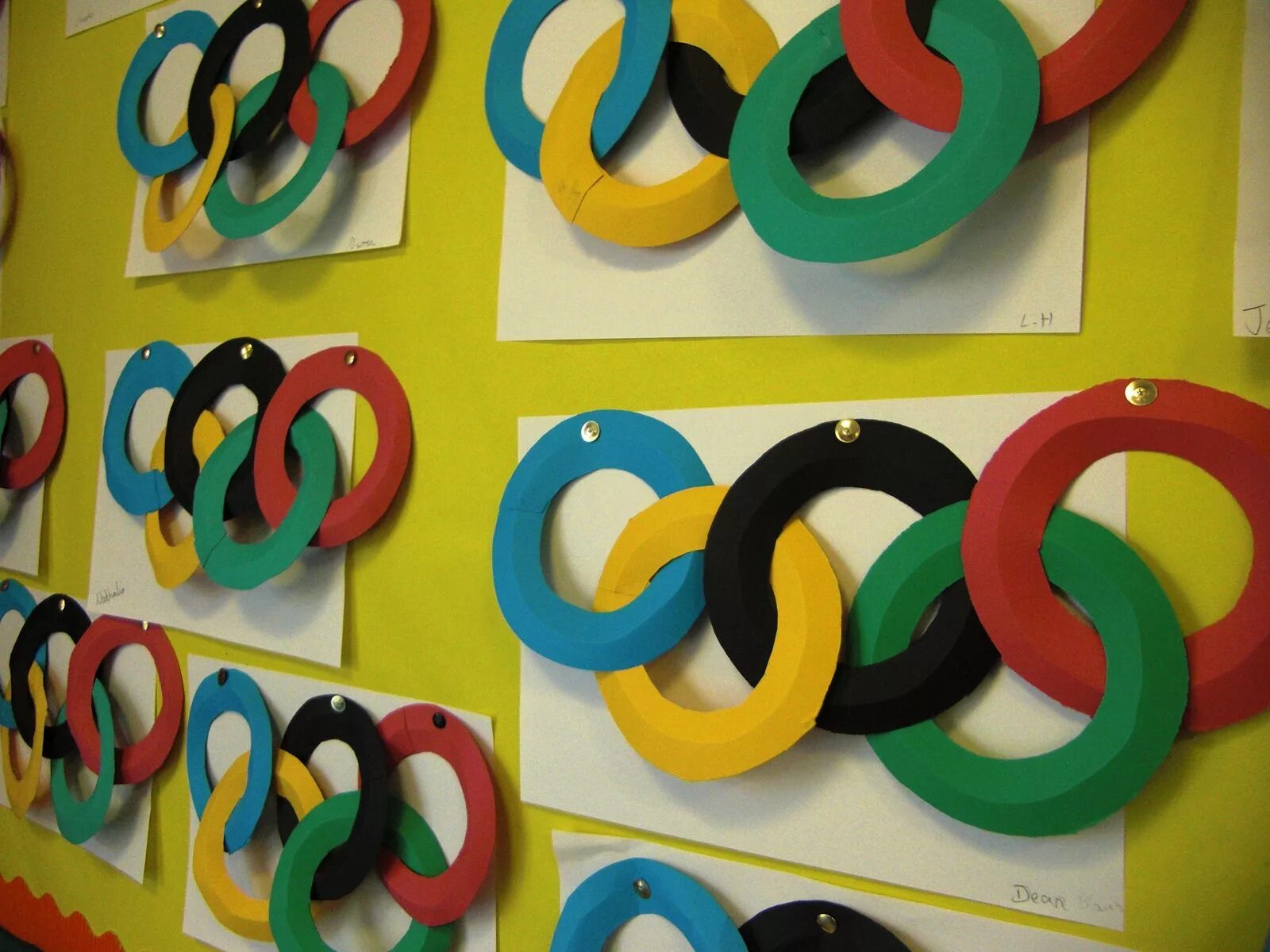 бумажные кольца из бумаги. аппликация кольцами. подделка из цветной. поделка олимпийские кольца. аппликация из колечек.