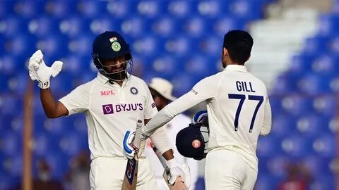 India’s Shubman Gill (R) shakes hands with his teammate Cheteshwar Pujara (...