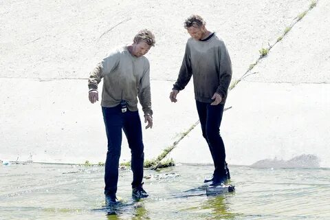 Liam Neeson and his stunt double stepping in water while filming. 