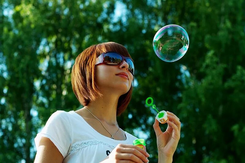 фотосет с мыльными пузырями. позитивная девушка. фотосессия с мыльными пузырями. женщины идут пузыри. выдувает пузыри.
