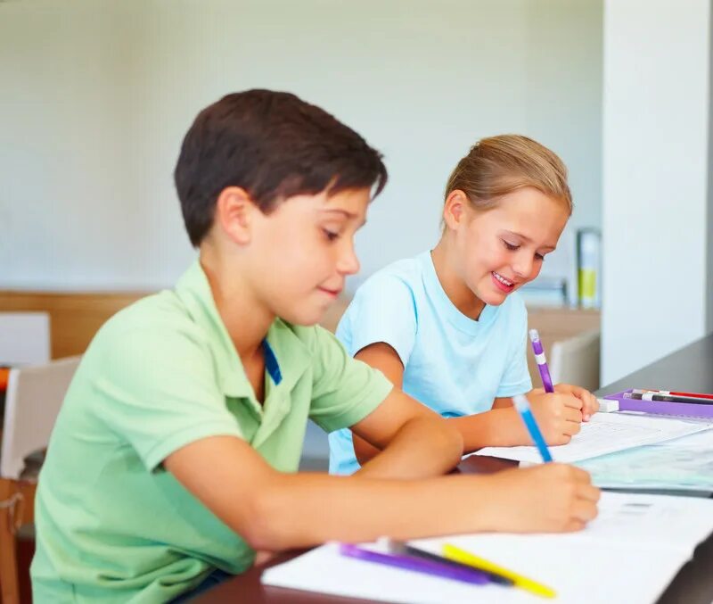 They doing their homework. Child writing homework.