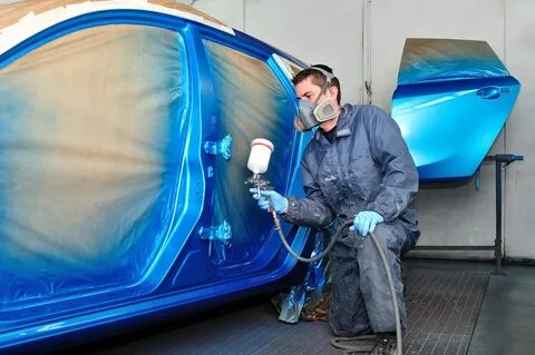 man spray the color on car panel