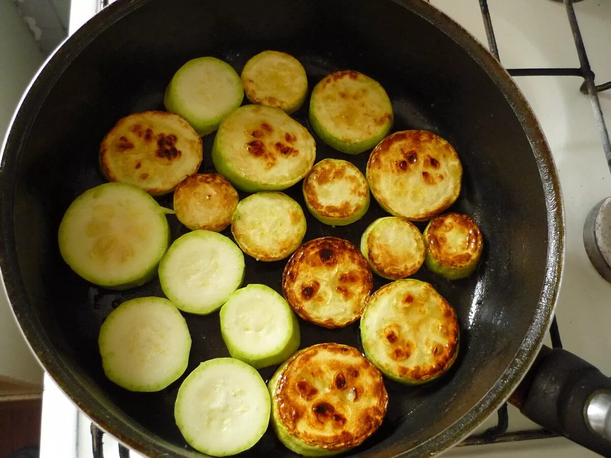 жареные кабачки. кабачки без жарки. кабачки жареные на сковороде с чесноком. кабачки на сковороде. обжаренные кабачки на сковороде.