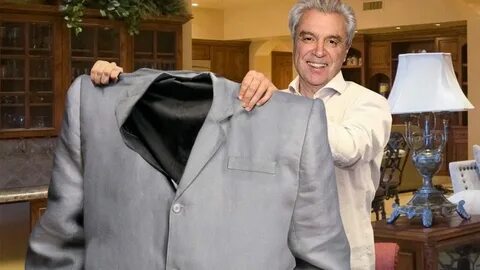 David Byrne Holds Up Old Suit To Show How Far He’s Come In Weight Loss Jour...