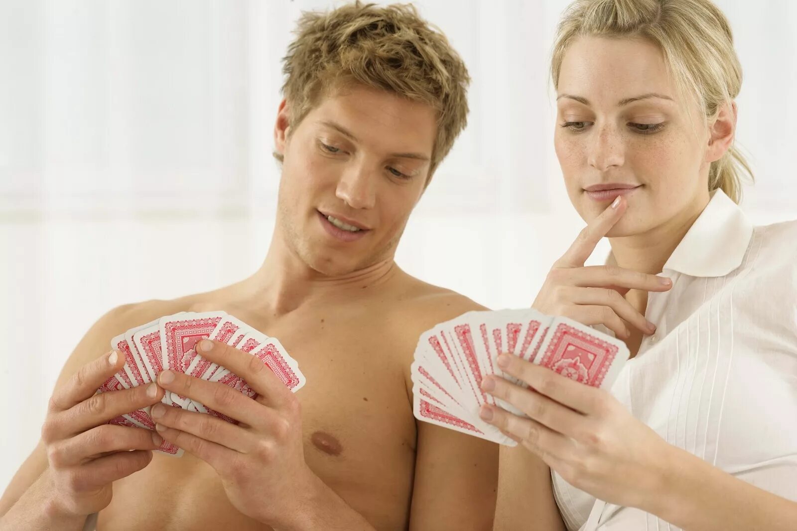 Мужчина и женщина играют в карты. Парень с девушкой играют в карты. Игры для супругов. Мужчина играет с женщиной.