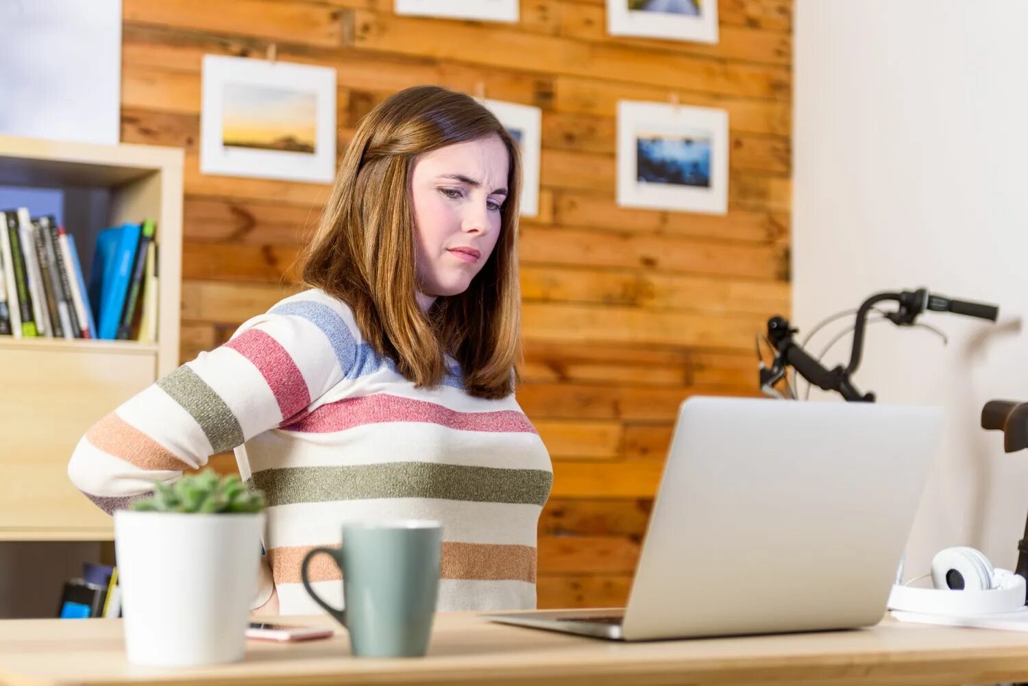 She is used to working. Woman with back Pain at work. Working woman back. Tired young woman having back Pain in Office. Working old woman with back Pain.