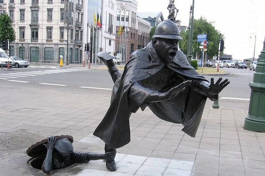 Почему люди создают необычные памятники. Памятник полицейскому в Брюсселе. Памятник шутка над полицейским Брюссель. Шутка над полицейским Брюссель Бельгия. Памятник смеху Германия.