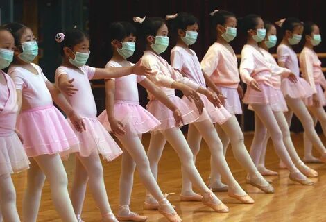 Children attend ballet lessons wearing masks to protect themselves from sev...