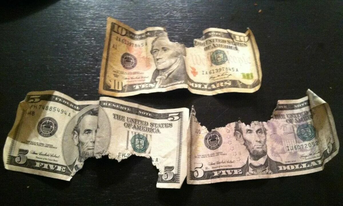 Ветхие банкноты. Порванный доллар. Поврежденные купюры. Изношенные банкноты.