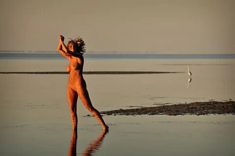 Caucasian teen Marilyn Winters see her naked reflection in a tidal pool.