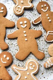 An aerial view of gluten free gingerbread people atop a white speckled cera...