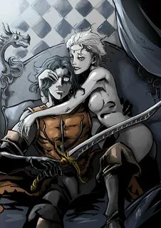 two people sitting on a couch with swords in their hands and one is holding...