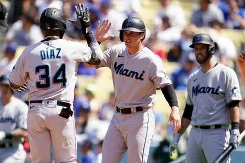 two-run home run at home plate with JJ Bleday, center, during the fourth in...