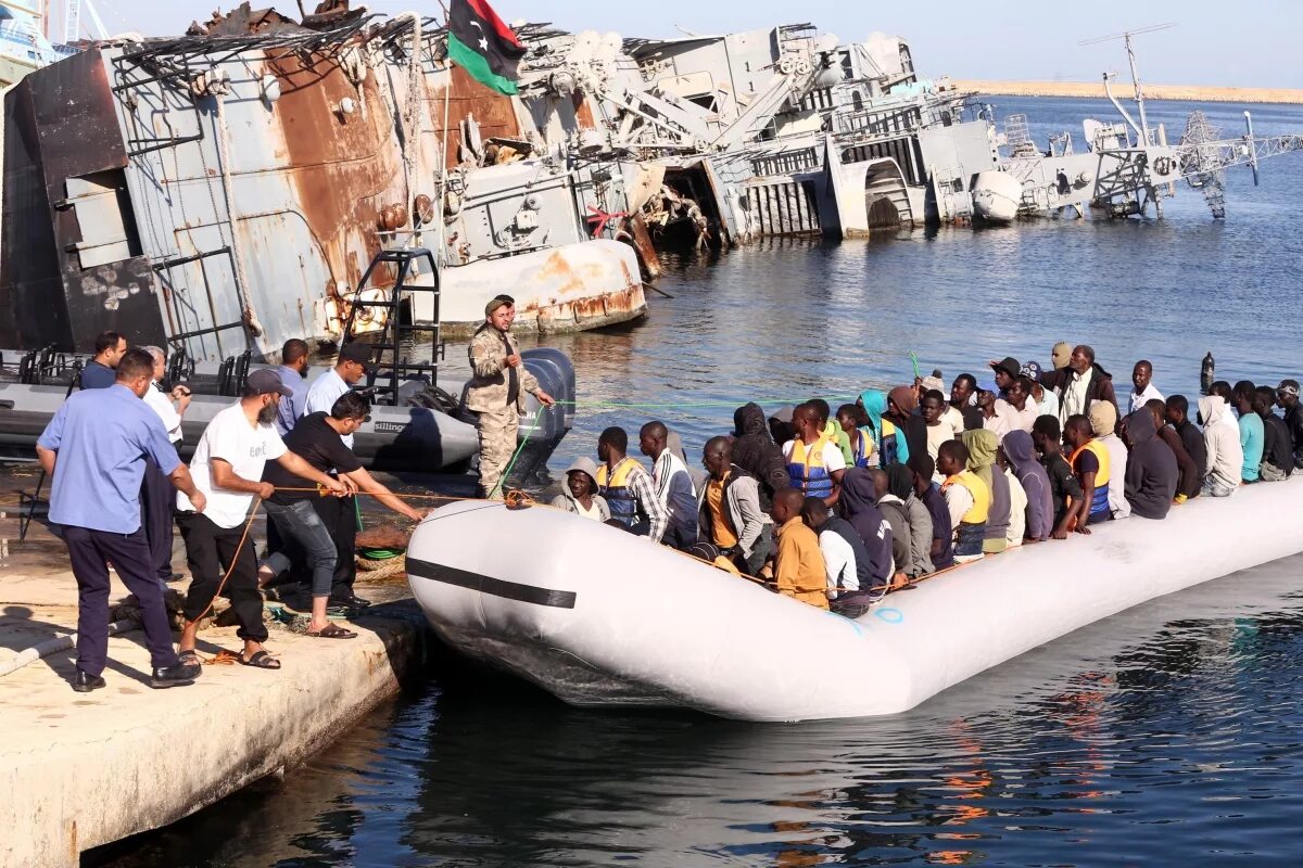 Imuga immigration. People smuggling. Migrant Fleet. Violins made from migrants Boats.