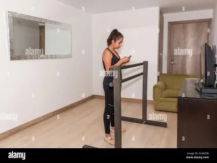 A teenage girl checks her gym and ballet class on the Internet on her cell ...