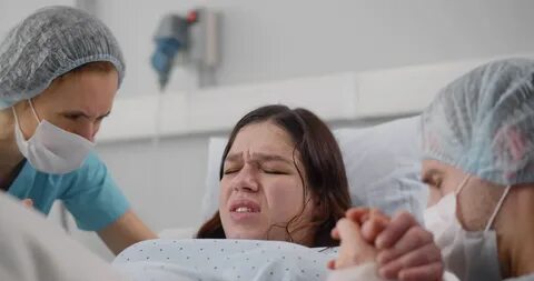 Женщина рожает ребенка в больнице