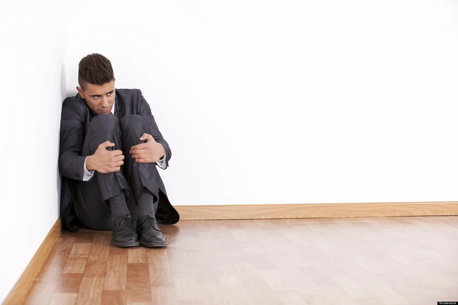 Man in the Corner. Man sitting at the Corner of his Room with Fear. Страх банкротства картинки.