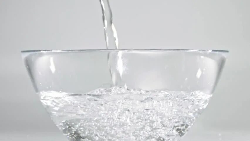 Plain water. Water in a bowl. water bowl. glass water bowl. poured water into paper.