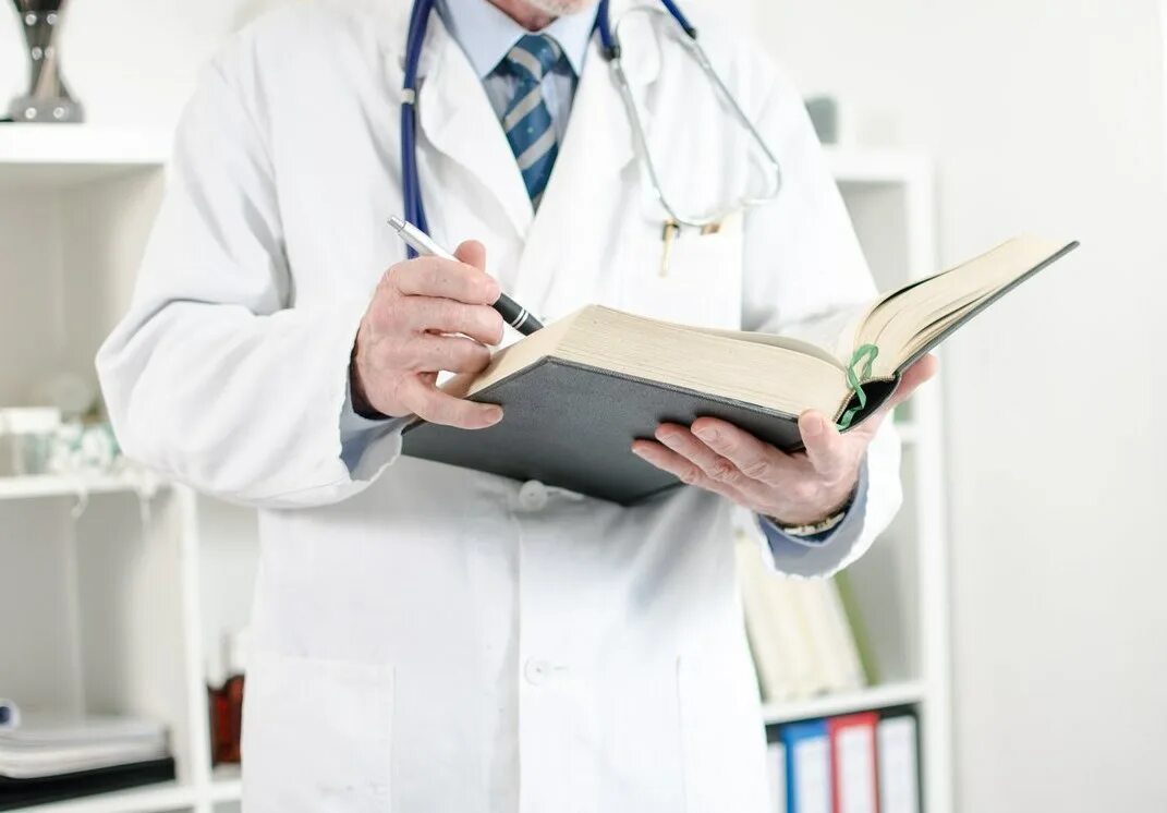 архиве врач. врач читает книгу. чтение врач фото.