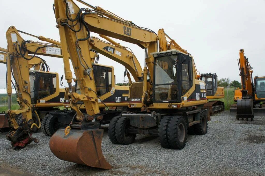 Колесные экскаваторы caterpillar m315d. Caterpillar м 315. Экскаватор 315. Экскаватор 315. Колесный экскаватор caterpillar m315d с грейфером.