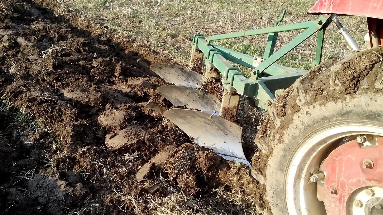 Плуг для вспашки земли. Вспашка плугом. Вспахивание земли плугом. Вспашка огорода плугом. Вспашка трактором плугом