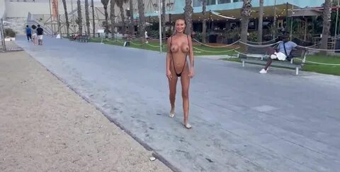 Naked model Monika Fox teasing with her boobs on the beach.
