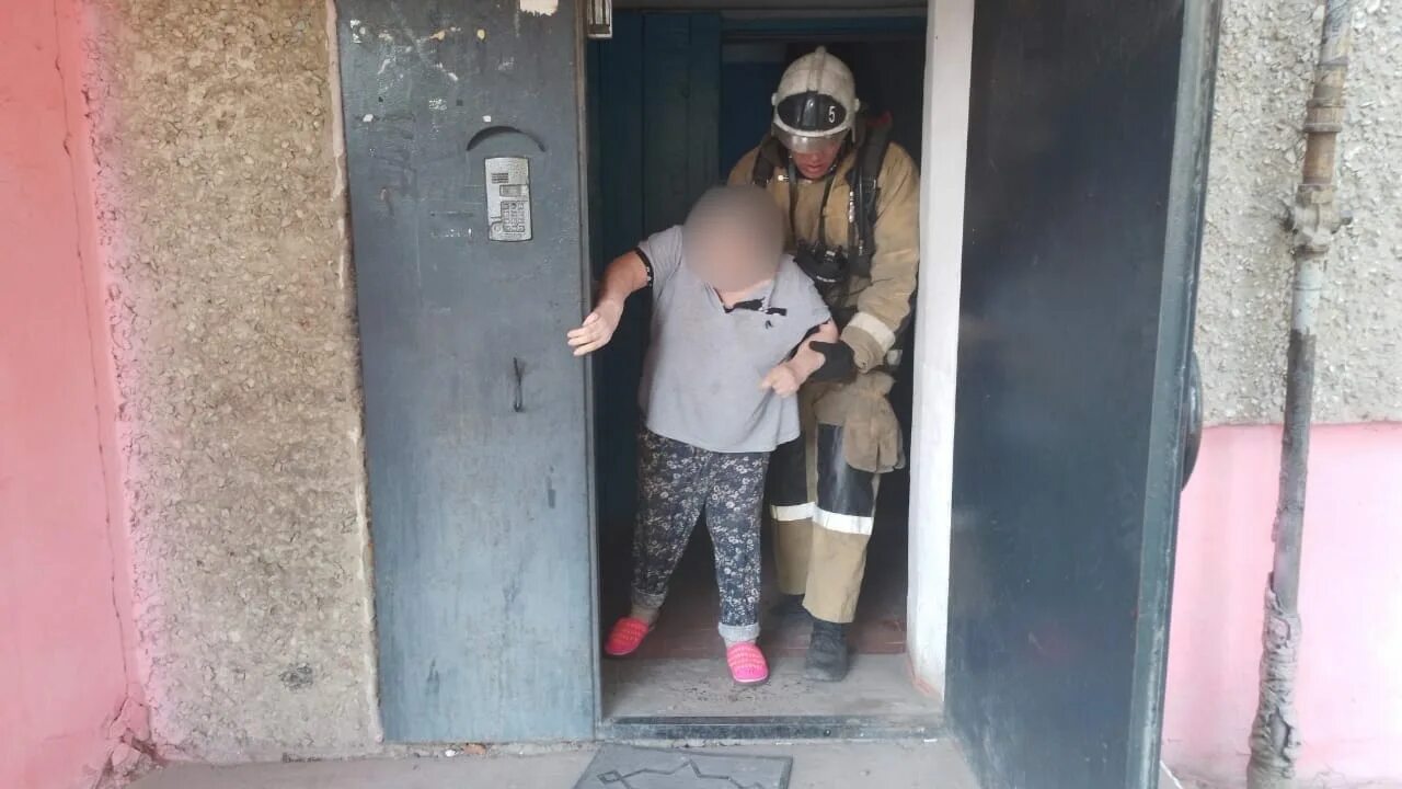 В подъезде девятиэтажного жилого дома сильное задымление. Женщина в подъезде. пожар в подъезде. подъезд пятиэтажки.