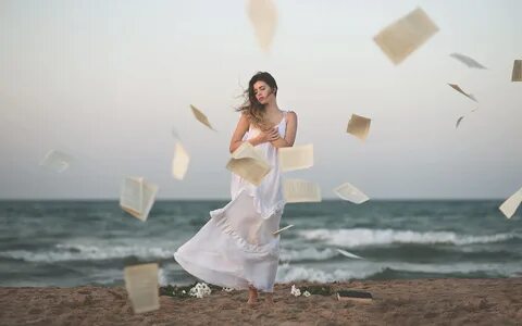 women outdoors, women, sea, paper, windy, hair blowing in the wind.