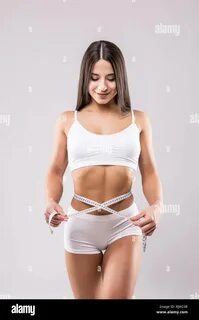 Download this stock image: Fitness young woman taking body measurements iso...