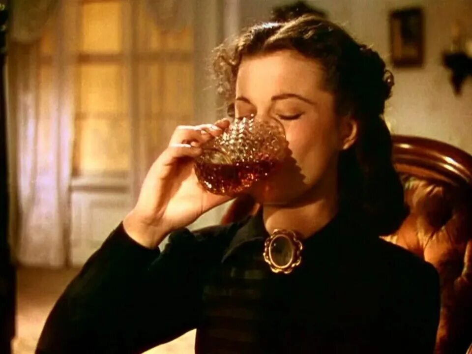 Девушка с виски. Женщина пьет коньяк