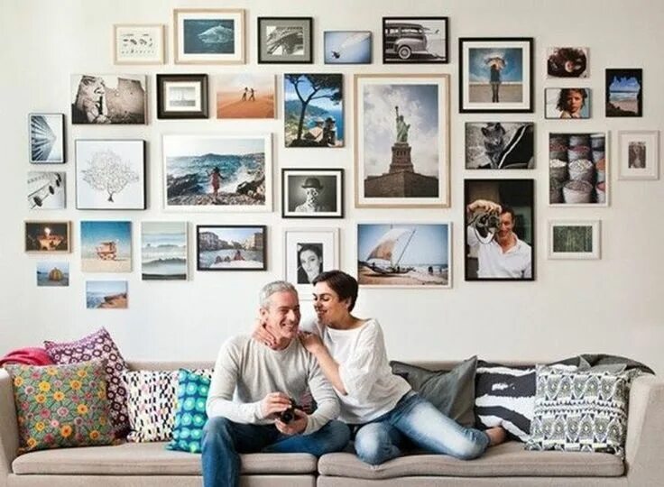Wall picture frames arrangement on the peach wall