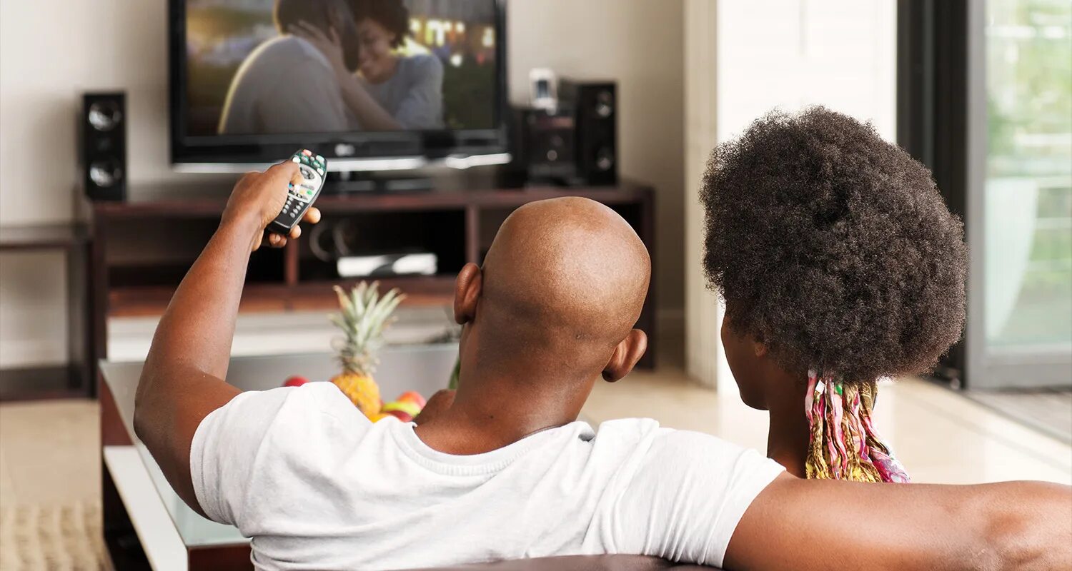 Black men watching TV. Black guy laugh watching TV. Old man watching TV. Black man steals TV.