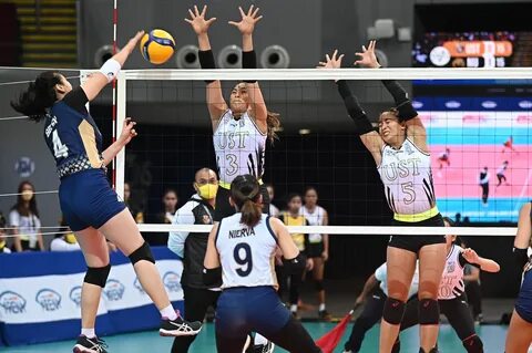 National U’s Michaela Belen scores through a double UST block. 