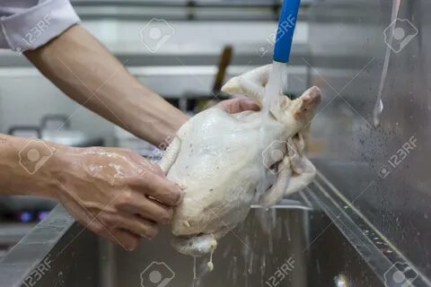 Hands washing and cleaning chicken at the kitchen sink - 84327063.
