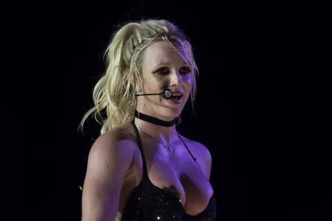 Britney Spears flashes her nipple covers as her bra slips down during energ...