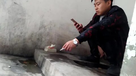 YOUNG CHINESE MEN AT THE TOILET. 