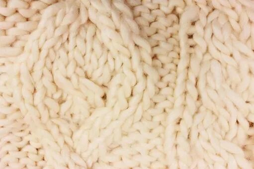 Вязка крупным планом. Вязаная ткань. Вязаная фактура. Вязаное полотно зеленое. Вязка крупным планом.