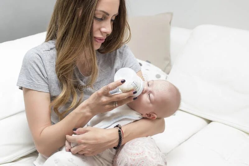 Daughters milk. Baby drinking Milk sitting.