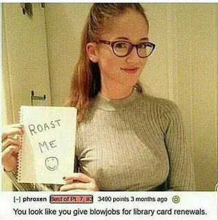 a woman in glasses holding up a sign 