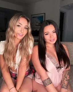 Kat Holmes is just sitting with her sister as they both are smiling. 