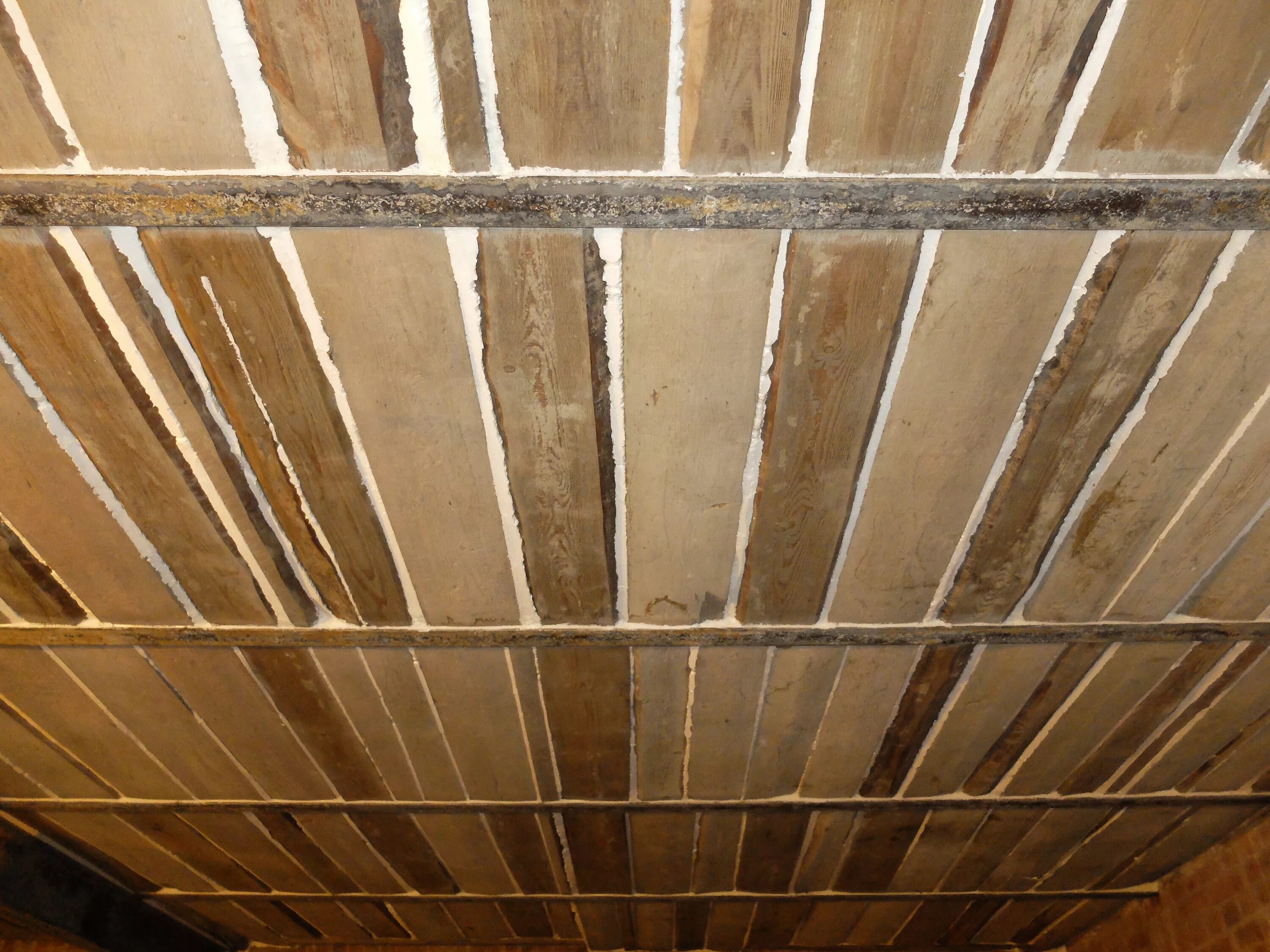 Трещины бани. Щели в деревянном потолке между досками. Щели между досками на потолке. Щели деревянный потолок. Заделка щелей в деревянном потолке.