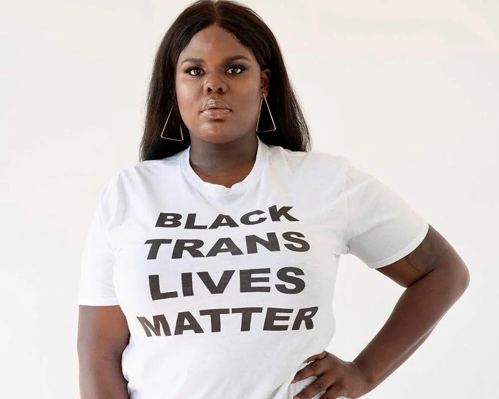 Are women real. Trans women are women. Trans woman. Black woman in feminine Shirt. Trans women are problem for women.