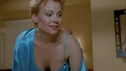 Gail O’Grady shows nice cleavage while talking to some guy.